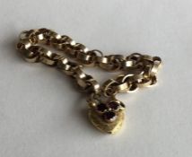 A good Victorian gold bracelet with garnet set pad