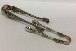 A pair of Victorian cast silver sugar tongs togeth