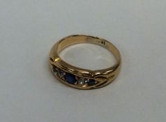 A sapphire and diamond five stone gypsy set ring i