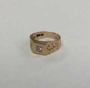 A gent's 9 carat gypsy set ring with central diamo