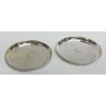 A pair of Edwardian circular silver pin dishes. Bi