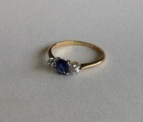 An 18 carat sapphire and diamond three stone ring