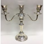 A silver candelabra with bead work decoration. Lon
