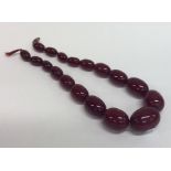 A graduated string of red amber beads with conceal