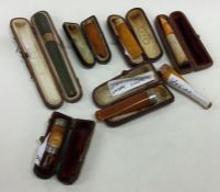 A selection of silver and gold mounted cigarette h
