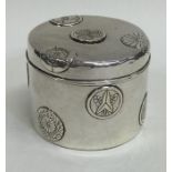 A cylindrical Japanese silver box decorated with f