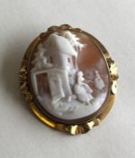 An oval cameo of a village scene in pinch-back fra