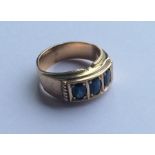 A heavy gent's sapphire three stone ring. Approx.