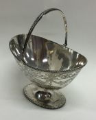 An Edwardian silver sugar basket with swing handle