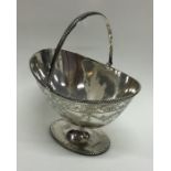 An Edwardian silver sugar basket with swing handle