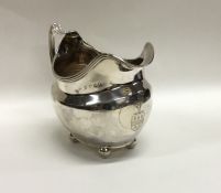 A Georgian silver cream jug with reeded rim to bal