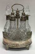 A heavy Georgian five bottle silver cruet on sprea