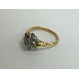 An 18 carat diamond cluster ring in the form of a