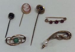 A bag containing 9 carat gem set stick pins and ba