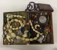 A box containing beads and other costume jewellery