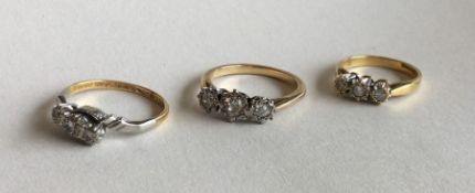 Three 18 carat and diamond rings. Approx. 8.3 gram