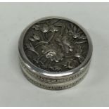 A small circular Chinese silver pill box decorated