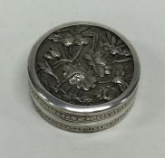 A small circular Chinese silver pill box decorated