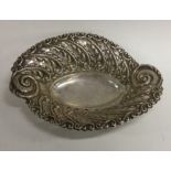 An embossed Edwardian silver bonbon dish decorated