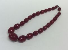 A graduated string of red amber beads with conceal