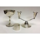 A stylish silver candlestick together with a silve