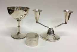 A stylish silver candlestick together with a silve