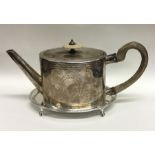 A good Georgian oval silver teapot with bright cut