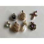 A group of 9 carat gem set pendants and lockets. A