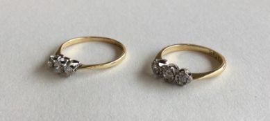 Two 18 carat gold and diamond set three stone ring