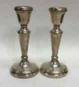 A pair of tapering silver candlesticks. London. By