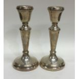 A pair of tapering silver candlesticks. London. By