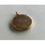 A circular 15 carat gold locket with loop top. App
