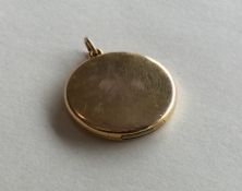 A circular 15 carat gold locket with loop top. App