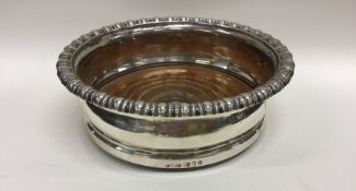 A Georgian silver wine coaster with gadroon rim. L