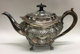 A good quality embossed silver teapot decorated wi