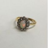 An opal and diamond cluster ring in 18 carat setti