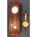 A small aneroid barometer together with an oak reg