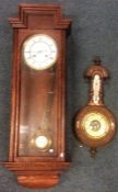 A small aneroid barometer together with an oak reg