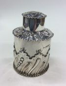 An Edwardian silver tea caddy of half fluted desig