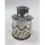 An Edwardian silver tea caddy of half fluted desig