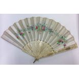 A carved Victorian fan with floral silk decoration