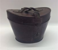 A leather travelling top hat case. Est. £30 - £40.