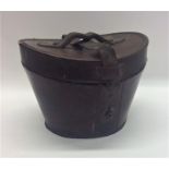 A leather travelling top hat case. Est. £30 - £40.