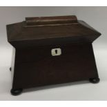 A rosewood sarcophagus shaped tea caddy with fitte