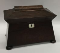 A rosewood sarcophagus shaped tea caddy with fitte