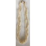 A good triple string of pearl beads with gold clas