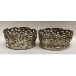 A rare pair of silver wine coasters attractively d