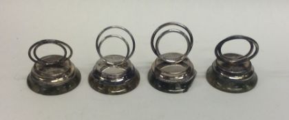 A set of four silver and agate menu holders on tap