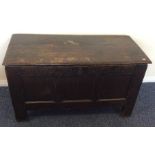 A small oak plank top coffer with panelled front.