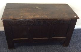 A small oak plank top coffer with panelled front.